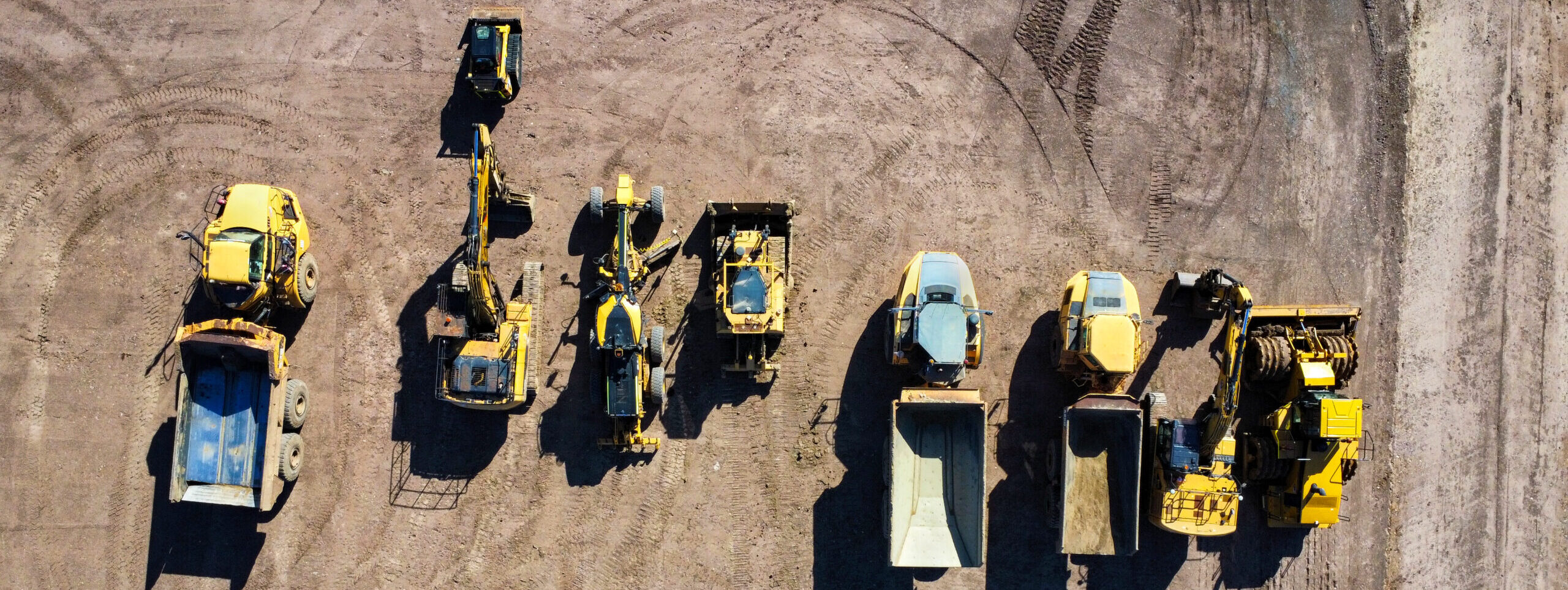 A construction site with parked machines, seen from above