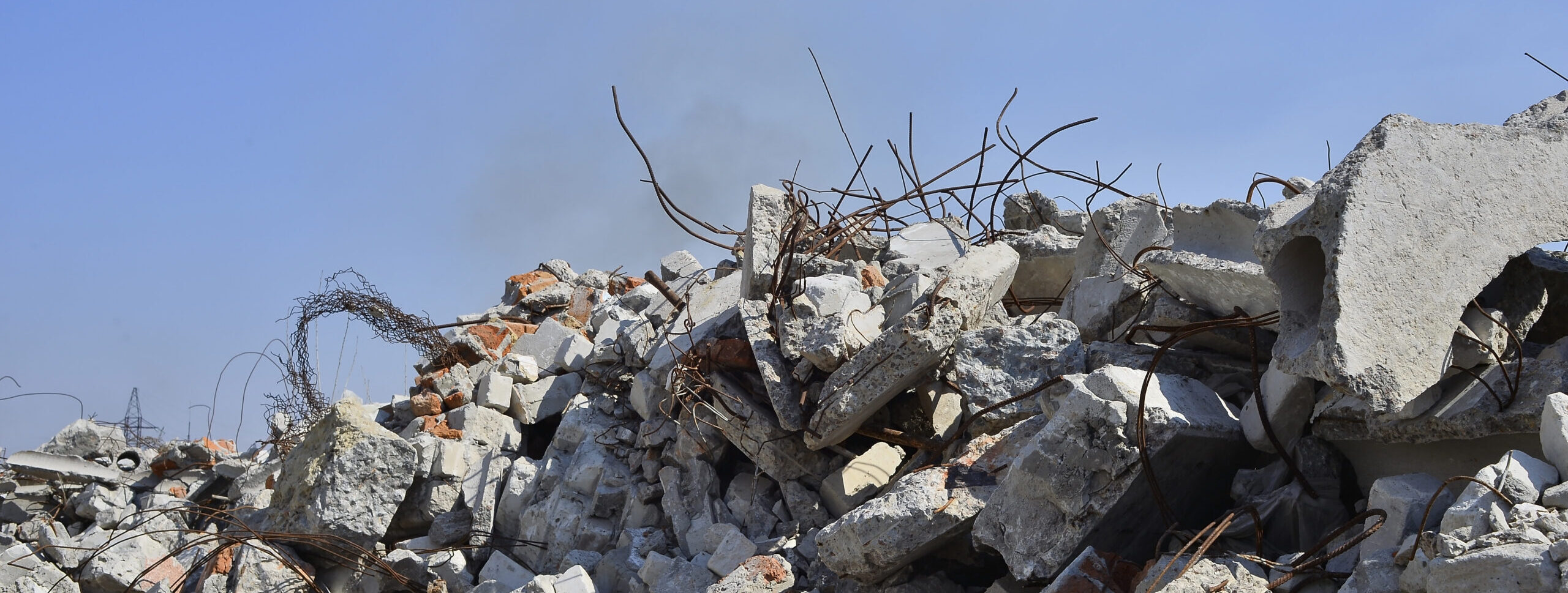 The rebar sticking up from piles of brick rubble. In the background, you can see the remnants of smoke clubs